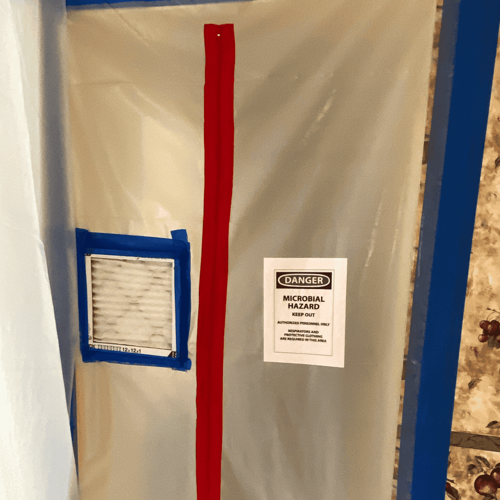 Fallen image with hazard warning sign, air vent, and protective barriers, emphasizing microbial hazard safety protocols during water damage restoration services by A+ Integrity Restoration.