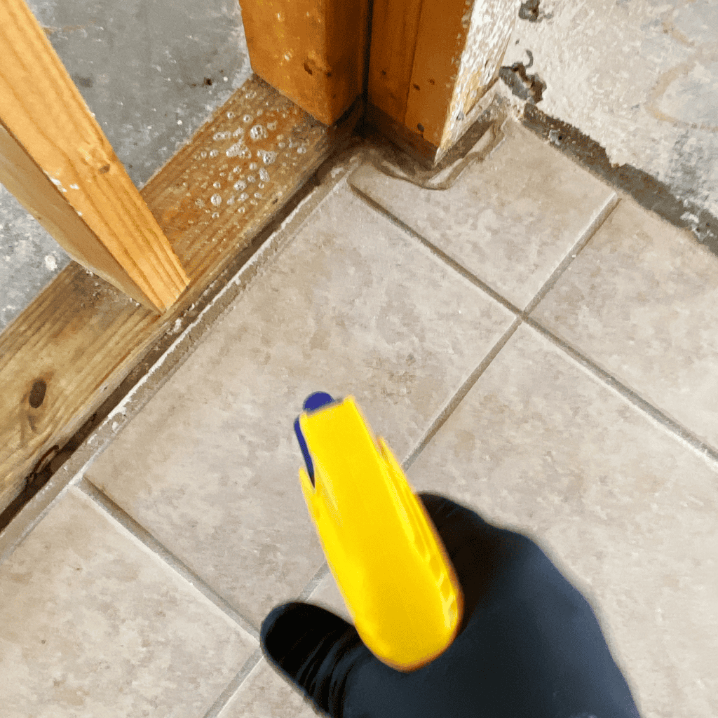 Crack repair and moisture testing at a water damaged tile floor.