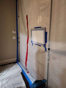 A+ Integrity Restoration offers expert water damage and mold remediation services, using professional equipment and techniques to restore properties quickly and effectively. Water damage restoration setup with plastic sheeting and air filter for mold prevention - A+ Integrity Restoration.