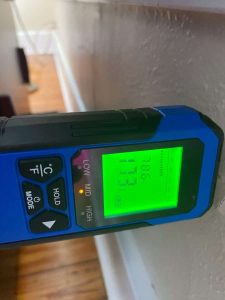 Home humidity level measurement for water damage and mold remediation. High humidity moisture reading on digital hygrometer in home, ideal for water damage restoration and mold prevention services.