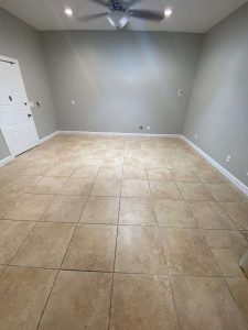 A room with newly installed ceramic tile flooring, showcasing professional water damage restoration services by A+ Integrity Restoration, highlighting flooring repair and mold removal expertise. Ceramic tile flooring after water damage restoration, clean indoor room by A+ Integrity Restoration.