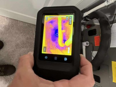 Infrared thermal camera used for moisture assessment and leak detection in building structures. Thermal imaging inspection for water damage detection and mold prevention at a residential property by A+ Integrity Restoration.