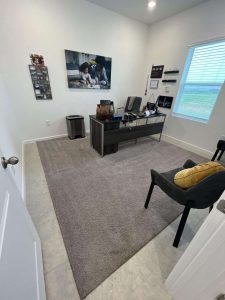 A professional property damage restoration office with a clean, organized workspace, highlighting expert water damage repair and restoration services provided by A+ Integrity Restoration. Restoration office space after water damage repair, featuring clean walls, a desk with equipment, and a comfortable chair, illustrating professional property damage restoration services.